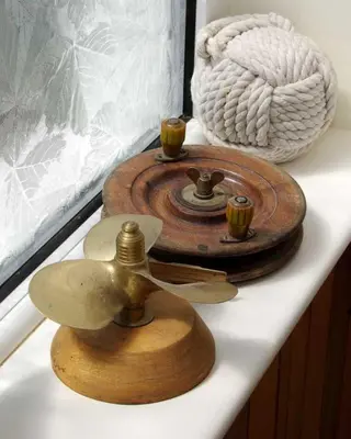 a wooden clock with two cups on a table at Seaview in Looe