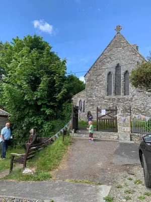 a small child standing in front of a church at The Old Wagon House in Saint Clether