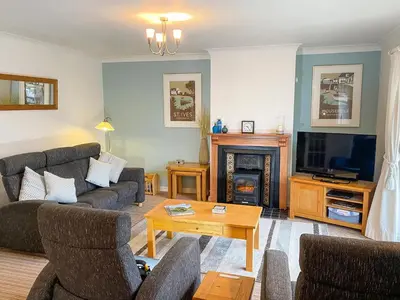 a living room with two couches and a fireplace at Spinnakers in Falmouth