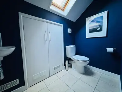 a blue bathroom with a toilet and a sink at 