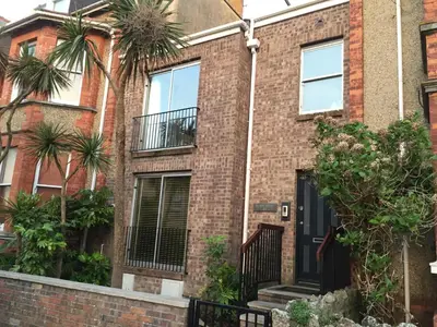 a brick house with a black door and windows at 