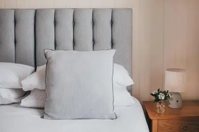 a bed with a white pillow on top of it at The Bay Hotel in Coverack