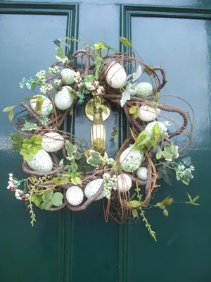a wreath with eggs and plants on a door at Woodlands in Looe