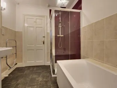a bathroom with a tub and a shower and a sink at Higher Tumrose in Blisland