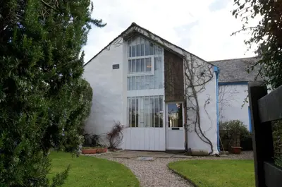 a white house with a white door at Regatta Cottage in Feock