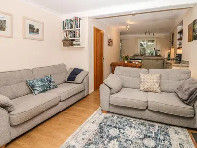 a living room with two couches and a kitchen at Quarry Cottage in Flushing