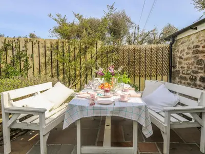 a table and two chairs on a patio at Evergreen in Breage