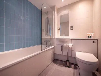 a bathroom with a toilet and a tub and a sink at The Valley in Perranwell
