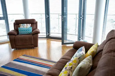 a living room with a couch and a chair at Horizons Apartments Newquay in Newquay