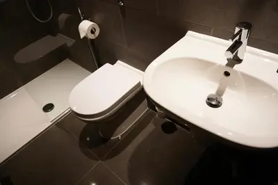 a bathroom with a white sink and a toilet at Ocean Views 4 in Newquay
