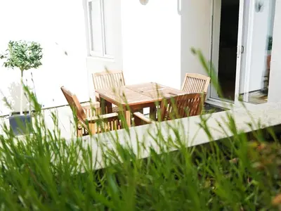 a wooden table and chairs on a porch at Ocean Views 4 in Newquay