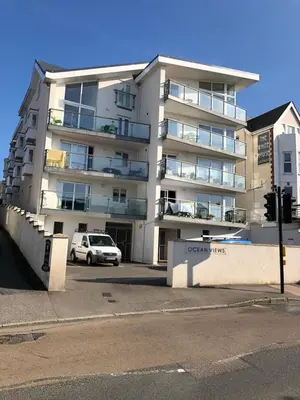 an apartment building with a car parked in front of it at Ocean Views 4 in Newquay