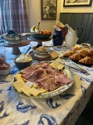 a table with a plate of meat and pastries on it at The Crown Inn in Lanlivery