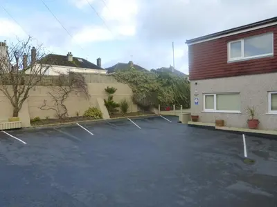 a parking lot in front of a building at Chynoweth Mews in Newquay