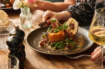a plate of food on a wooden table with a plate of food at Chainlocker in Falmouth