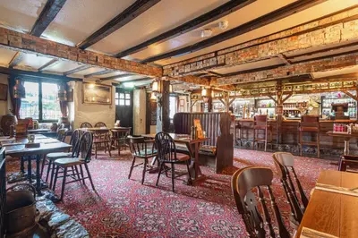 a restaurant with tables and chairs and a bar at The Jamaica Inn, Bodmin, Cornwall - The Coaching Inn Group in Bolventor
