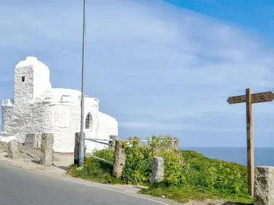 an old white church on the side of a road at Towan View Loft in Newquay