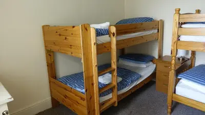 a couple of bunk beds in a room at Longbeach- Adults Only in Newquay