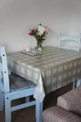 a table with a vase of flowers on it at The annex, Ruthvose in Saint Columb Major