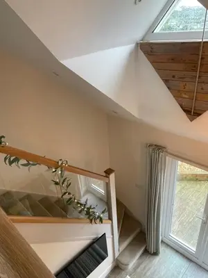 a staircase in a house with a window at Little Fernleigh in Perranporth