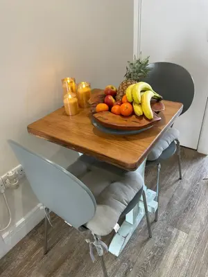 a plate of fruit on a wooden table at Little Fernleigh in Perranporth