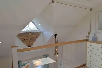 a staircase in a house with a window at Little Fernleigh in Perranporth