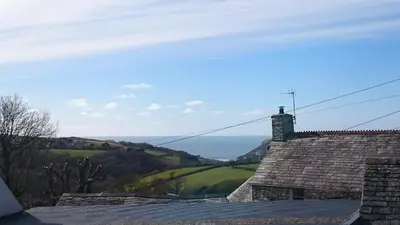 a roof of a house with a view of the countryside at The Hayloft in Bude