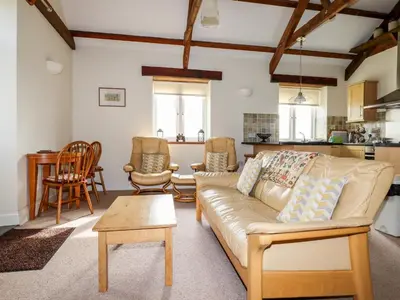a living room with a couch and a table at Wheal Kitty in Newlyn East