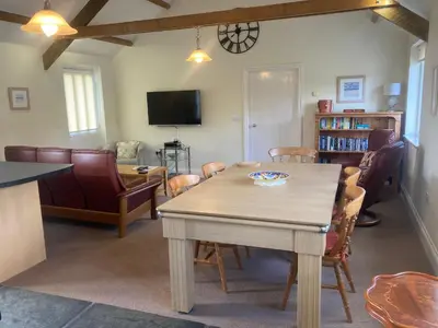 a living room with a table and chairs at Wheal Hart in Newlyn East