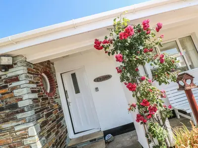 a door of a house with flowers on it at The Shack in Mawgan Porth