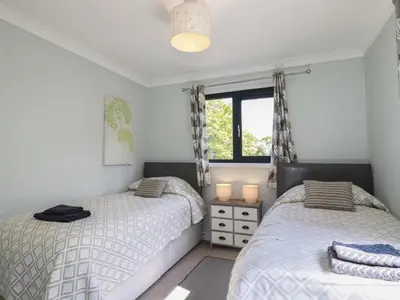 a bedroom with two beds and a window at The Station Flat in Newlyn East