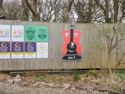 a sign on a fence with a train on it at The Station Flat in Newlyn East
