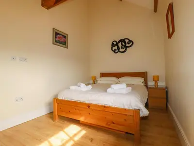 a bedroom with a bed with two towels on it at Wheal Honey in Newlyn East