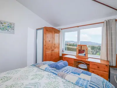 a bedroom with a bed and a desk and a window at The Annexe, Laburnum in Bugle