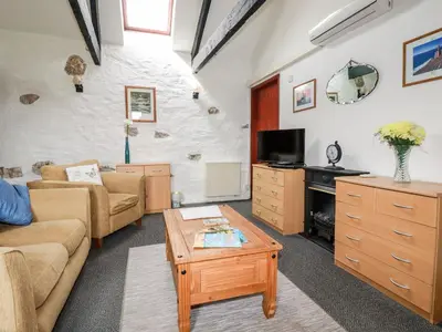 a living room with a couch and a coffee table at Ravens Croft in Lanivet