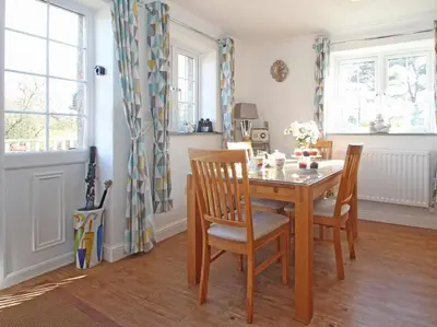 a dining room with a wooden table and chairs at Omalast in Truro