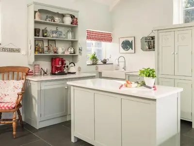 a kitchen with white cabinets and a white counter top at The Barn at Little Resugga in Bugle