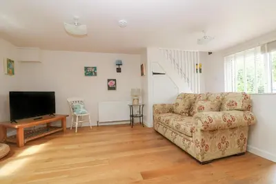 a living room with a couch and a television at Bolitho's Retreat in Saint Martins Green