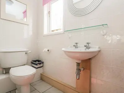 a bathroom with a toilet and a sink at Bolitho's Retreat in Saint Martins Green