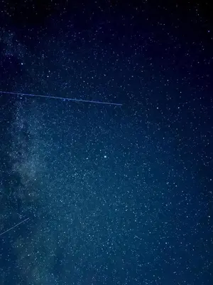 an airplane is flying in the night sky at Demelza Cottage Apartment in Bodmin