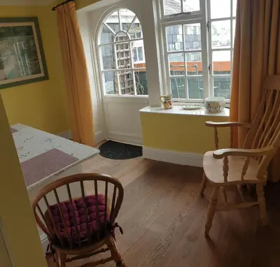 a room with two chairs and a table and a window at Polmarine in Polruan