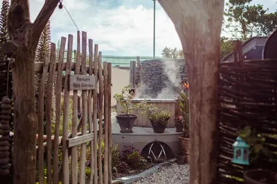 a wooden fence in a garden with potted plants at Bedruthan Hotel & Spa in Newquay