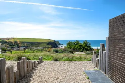 a brick wall with the ocean in the background at Bedruthan Hotel & Spa in Newquay