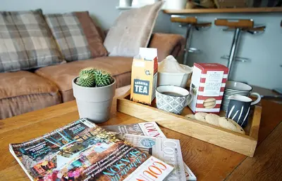 a coffee table with a tray of food on it at Ocean Views 3 in Newquay