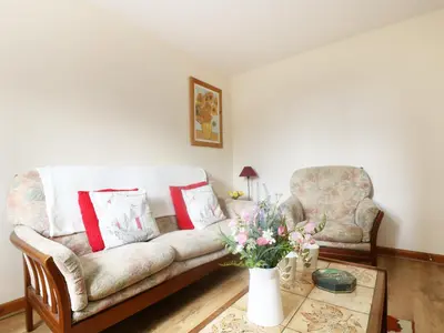 a living room with a couch and a table at The Old Granary in Launceston