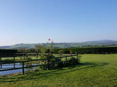 a kite flying in the sky over a field at The Shippon in Launceston