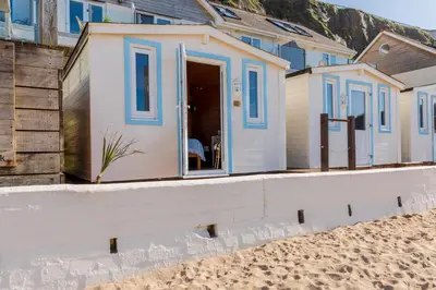 a beach house on the beach at Tolcarne Beach Colonial Restaurant and Rooms in Newquay