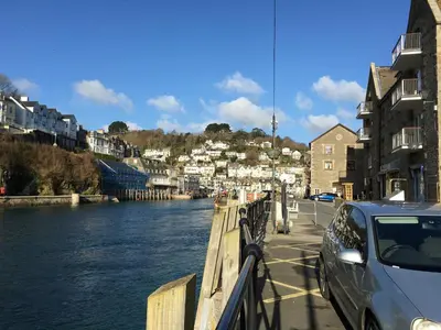 a car parked on a bridge next to a river at Sand Martin in Looe