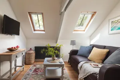 a living room with a couch and a tv at St Kew Escapes Nr Port Isaac in Saint Kew