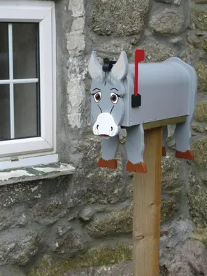 a mailbox with a cow head on the side of a building at The Little Cabin in St Ives
